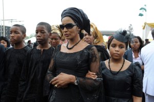 The widow of Nigeria's seccessionist leader Odumegwu Ojukwu, Bianca Ojukwu (C), and her children arrive to attend  the national inter-denominational funeral rites at Michael Opkara Square in Enugu, southeastern Nigeria, on March 1, 2012. Soldiers fired a 21-gun salute at the funeral of Odumegwu Ojukwu on Thursday as Nigerian leaders paid final respects to the man whose 1967 declaration of Biafran independence sparked a civil war. Forty-five years after he tried to split Nigeria asunder by proclaiming the Republic of Biafra, Ojukwu's coffin was draped in the national colours of white and green at the funeral service in the city of Enugu, attended by thousands.  Ojukwu died in November in Britain at the age of 78 but his body was only flown back on Monday. AFP PHOTO/ PIUS UTOMI EKPEI (Photo credit should read PIUS UTOMI EKPEI/AFP/Getty Images)